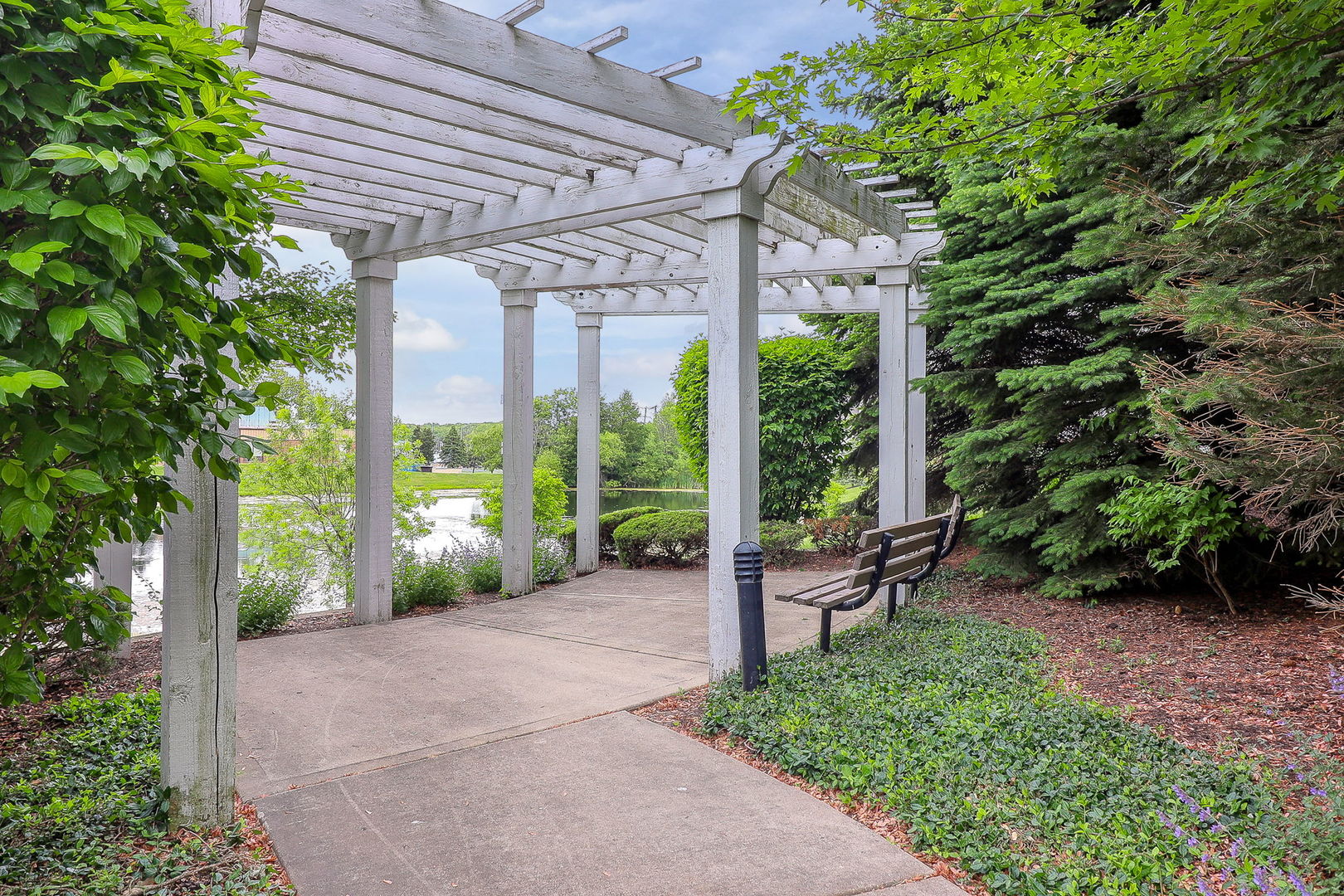 317 Timber Ridge Court, Unit 131 Joliet, IL 60431 - Photo 23 of 23 a view of a garden with plants and large trees