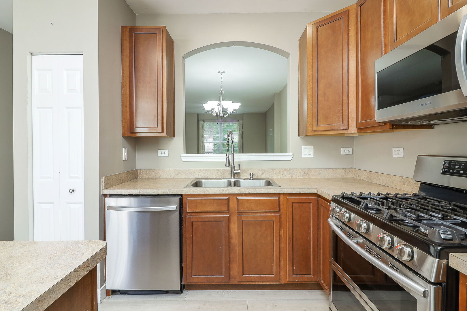 317 Timber Ridge Court, Unit 131 Joliet, IL 60431 - Photo 6 of 23 a kitchen with a sink and a stove top oven