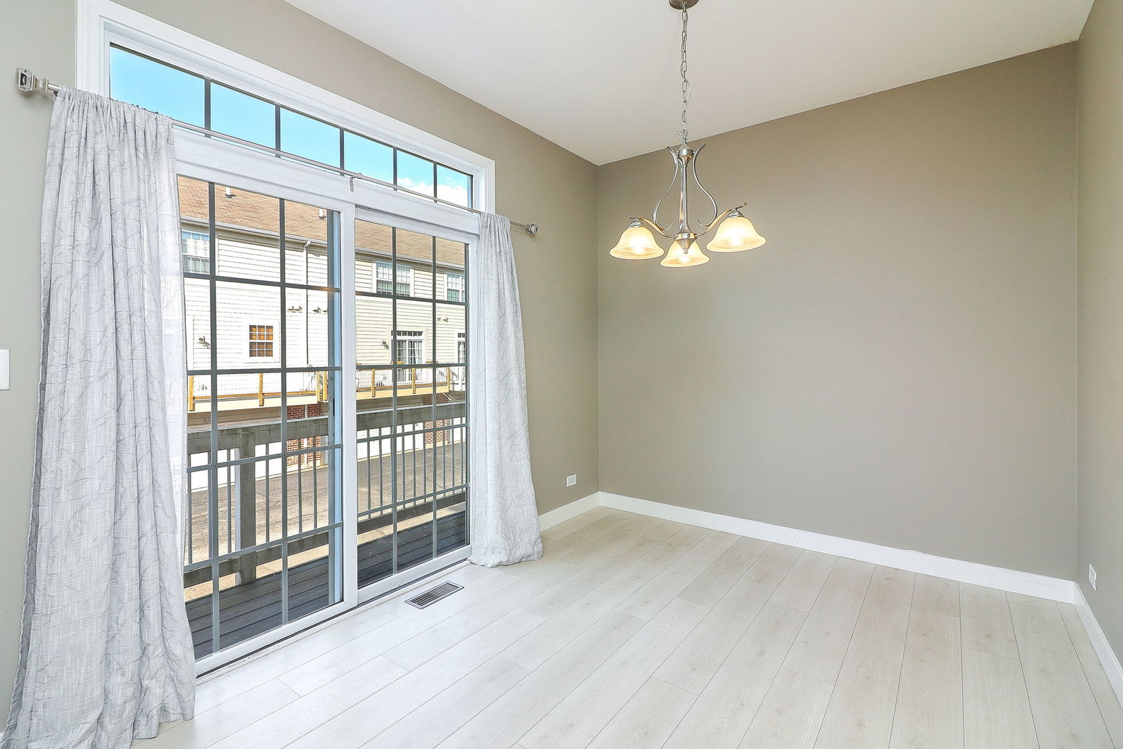 317 Timber Ridge Court, Unit 131 Joliet, IL 60431 - Photo 9 of 23 a view of a room with wooden floor and windows