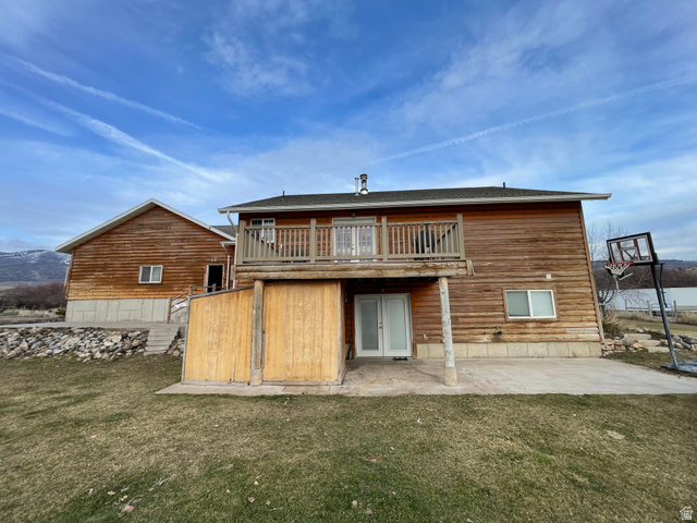 333 Lago Liberty Road Grace, ID 83241 - Photo 7 of 35 Back of property featuring a patio, a lawn, a balcony, and french doors
