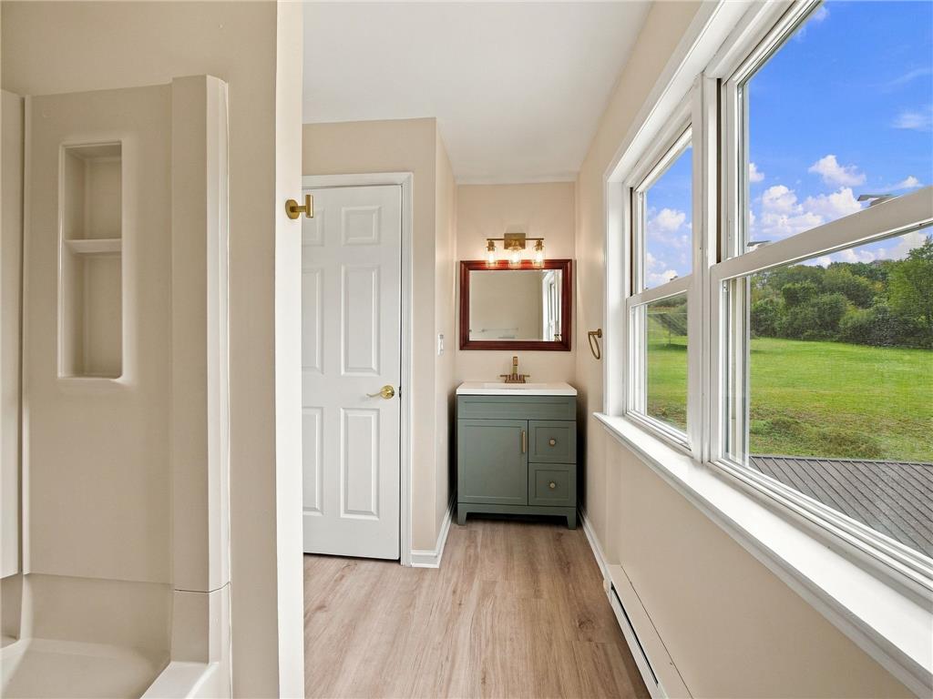 90 Gun Club Road Palmerton, PA 18071 - Photo 48 of 58 A window-lined wall framing serene pastoral views illuminates this neutral-toned bathroom space.