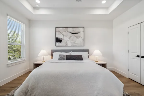 a bedroom with a bed and a painting on the wall