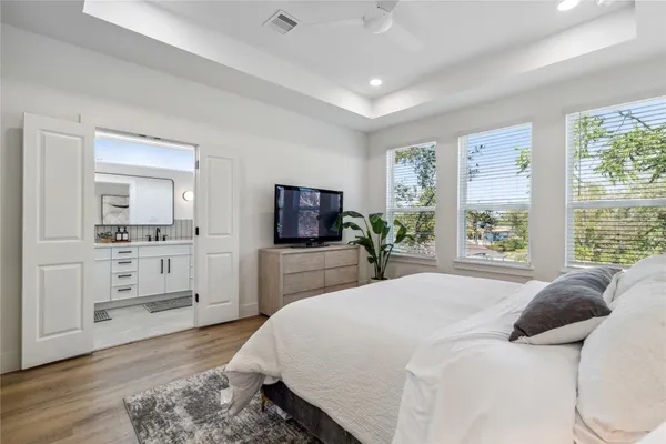 a bedroom with a bed and a flat screen tv