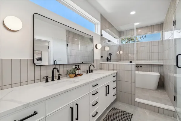 a bathroom with a double vanity sink mirror and