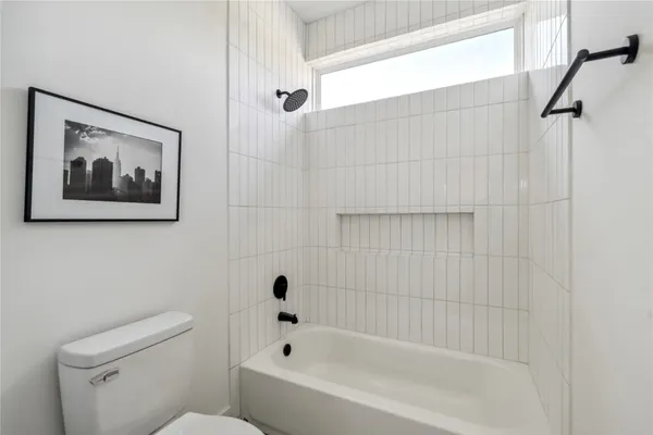 a bathroom with a bathtub and shower