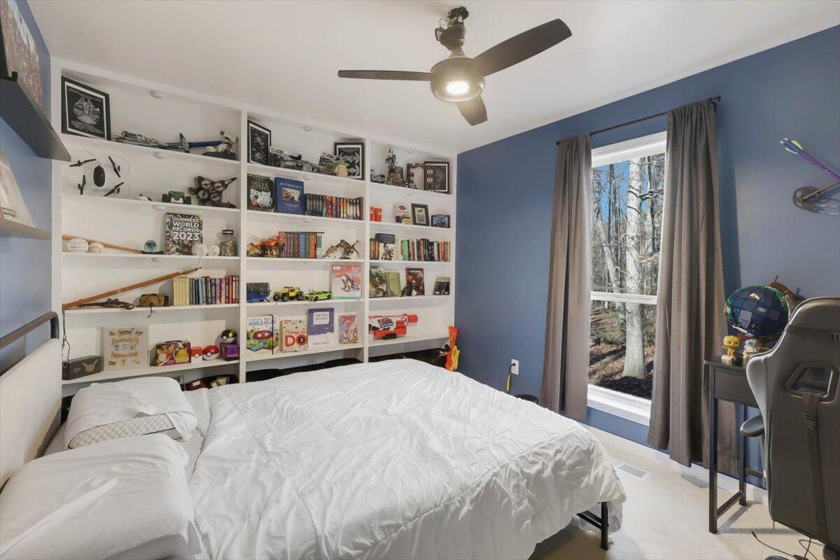 2265 Little Bend Road Signal Mountain, TN 37377 - Photo 18 of 31 a bedroom with a bed next to a window with a book shelf