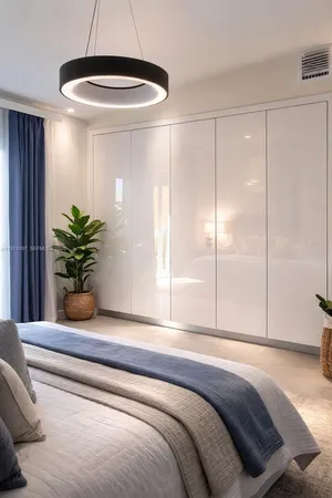 a bedroom with a large bed and a chandelier