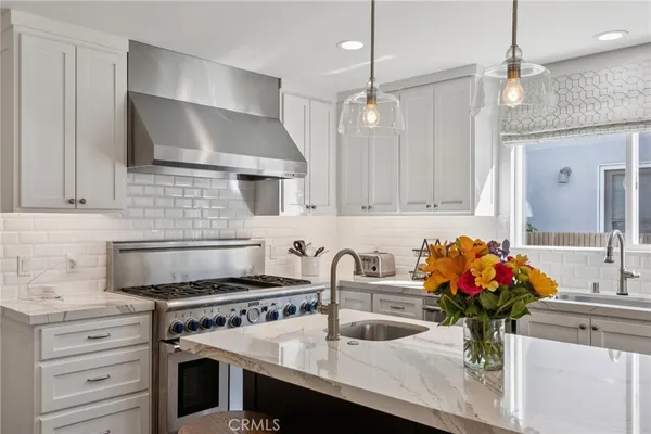 a kitchen with a refrigerator a sink and cabinets