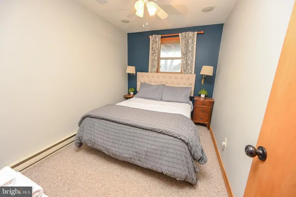 a bedroom with bed and a window