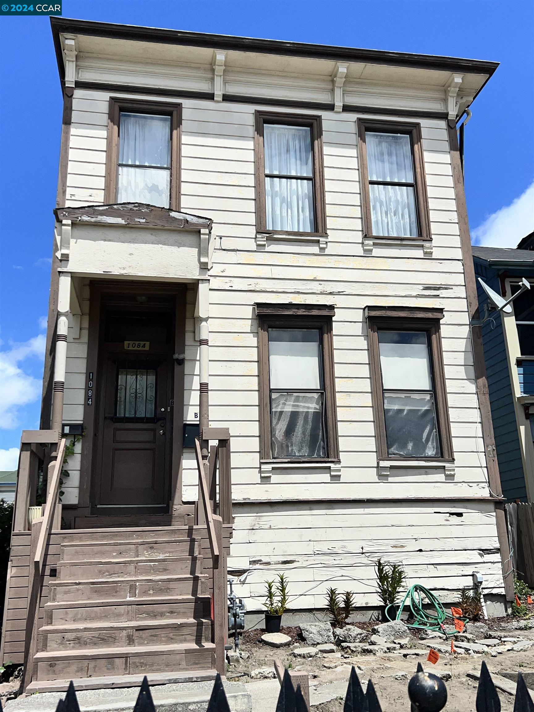 a front view of a house with stairs