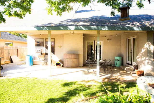 a view of a lobby with a floor to ceiling window and potted plants