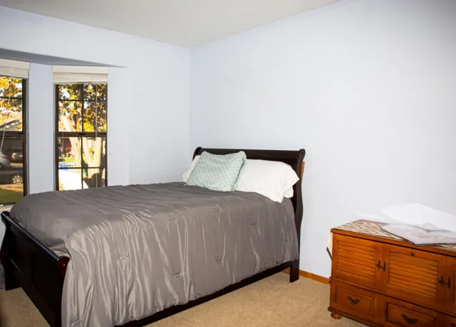 a bedroom with a bed and window