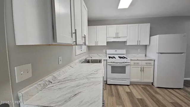 a kitchen with a white cabinets and white appliances