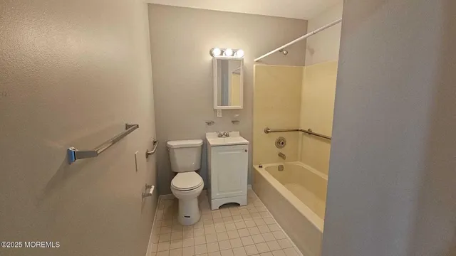 a bathroom with a bathtub toilet and a shower