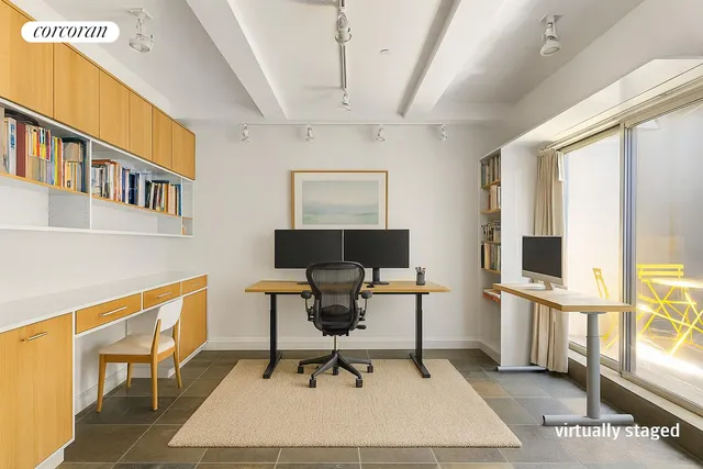 a view of a hallway with chairs and door