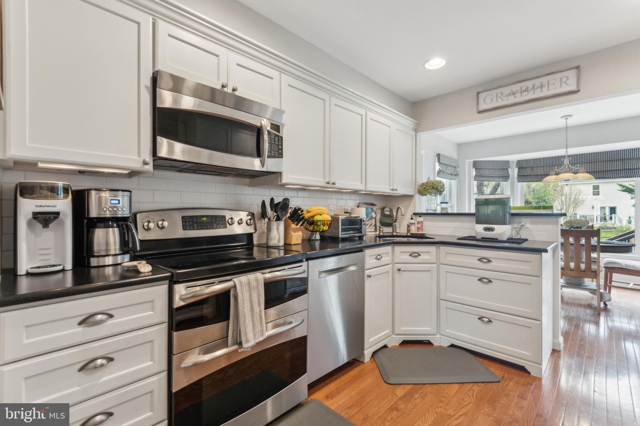 306 Saddle Ridge Road Annapolis, MD 21403 - Photo 18 of 44 a kitchen with stainless steel appliances granite countertop a stove a sink and a microwave