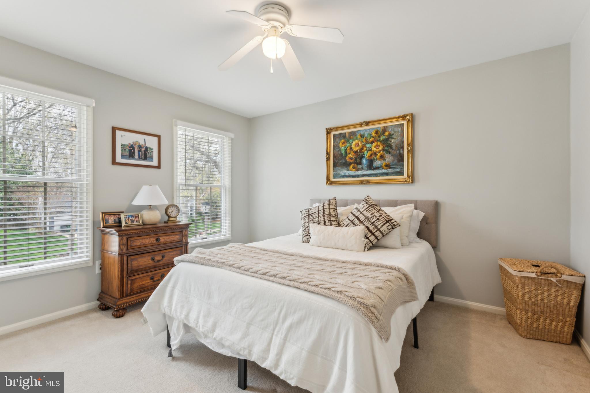 306 Saddle Ridge Road Annapolis, MD 21403 - Photo 22 of 44 a bedroom with a bed and a chandelier