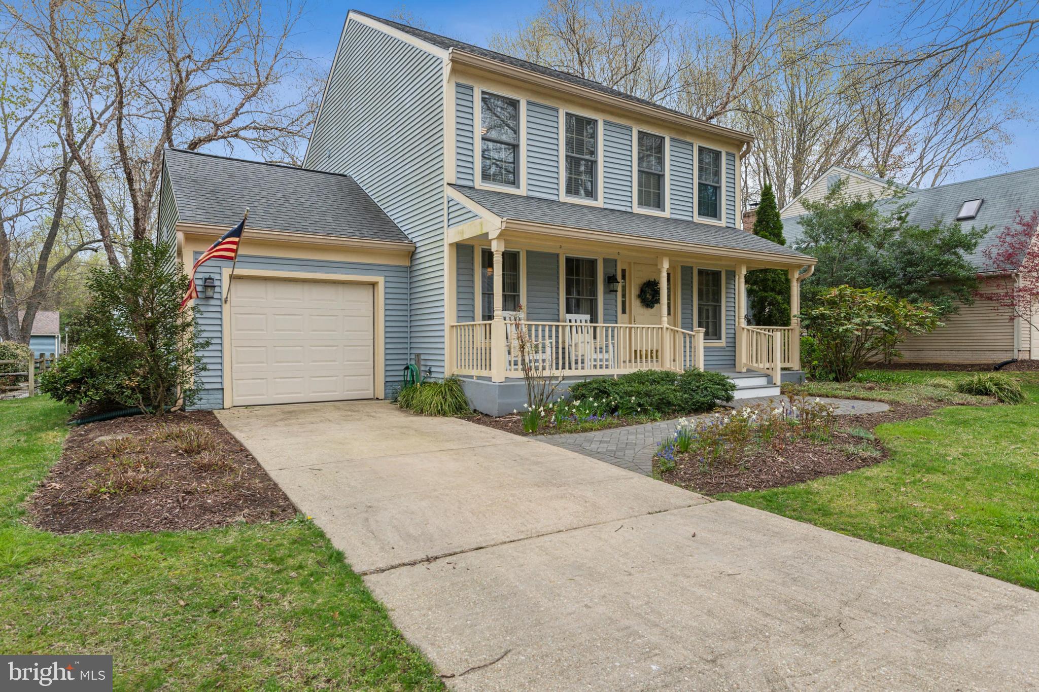 306 Saddle Ridge Road Annapolis, MD 21403 - Photo 3 of 44 a front view of a house with a garden and yard