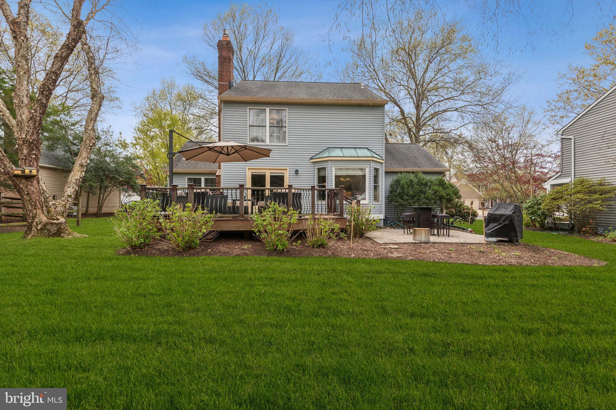 306 Saddle Ridge Road Annapolis, MD 21403 - Photo 35 of 44 a front view of a house with a garden and trees