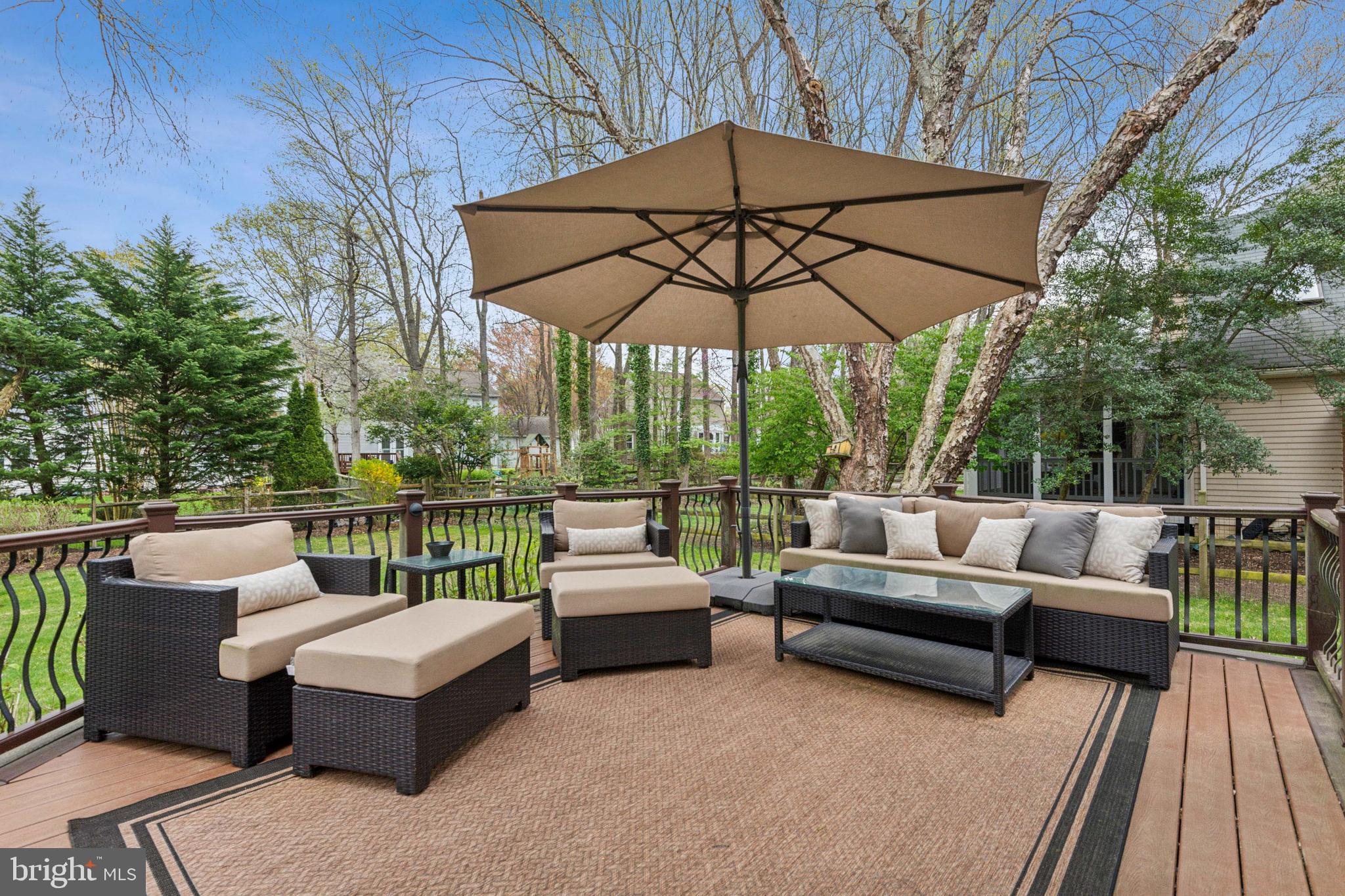 306 Saddle Ridge Road Annapolis, MD 21403 - Photo 40 of 44 a view of a patio with couches chairs under an umbrella