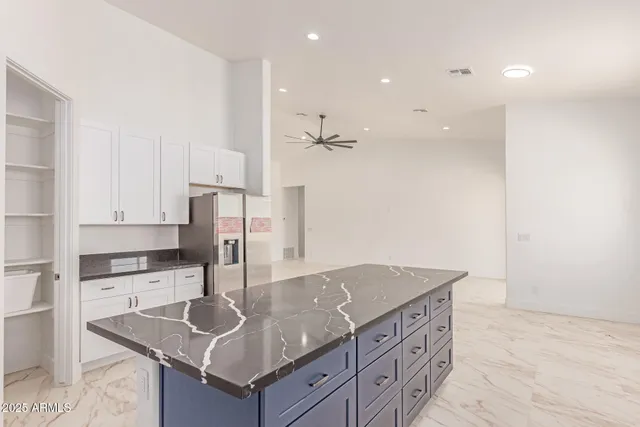 a kitchen with stainless steel appliances granite countertop a sink a stove and a refrigerator