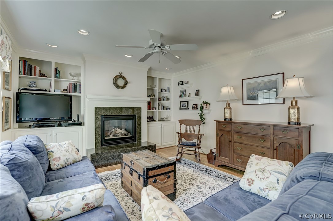 1607 Genito Road Crozier, VA 23039 - Photo 15 of 49 a living room with furniture a flat screen tv and a fireplace