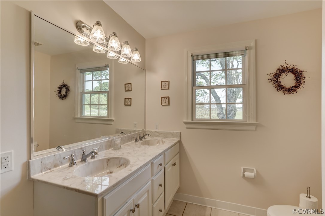 1607 Genito Road Crozier, VA 23039 - Photo 18 of 49 a bathroom with a granite countertop sink a large mirror and a toilet