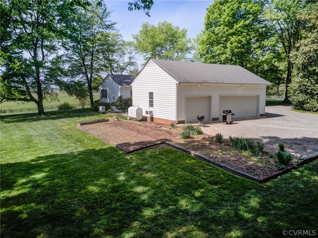 1607 Genito Road Crozier, VA 23039 - Photo 34 of 49 a backyard of a house with table and chairs
