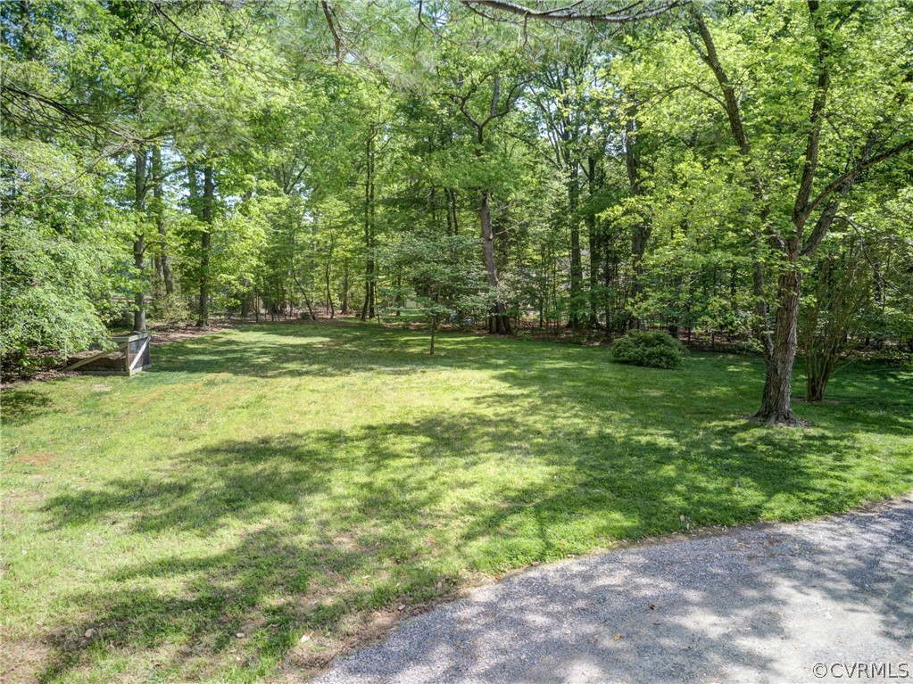 1607 Genito Road Crozier, VA 23039 - Photo 40 of 49 a backyard of a house with lots of green space and fountain