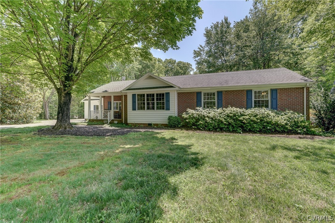 1607 Genito Road Crozier, VA 23039 - Photo 45 of 49 a front view of a house with a garden