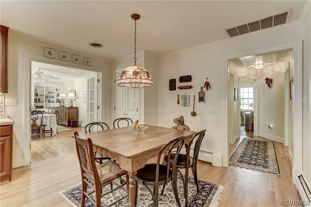 1607 Genito Road Crozier, VA 23039 - Photo 5 of 49 a view of a dining room and livingroom with furniture wooden floor a chandelier