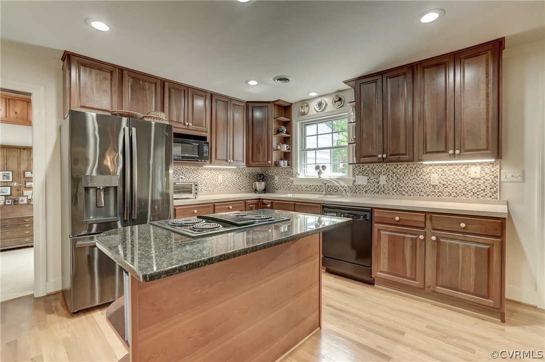 1607 Genito Road Crozier, VA 23039 - Photo 6 of 49 a kitchen with kitchen island granite countertop a sink stove and refrigerator