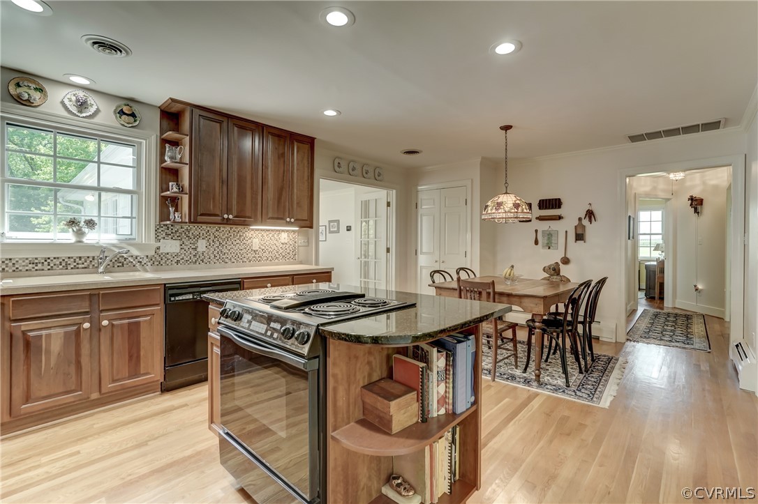 1607 Genito Road Crozier, VA 23039 - Photo 8 of 49 a kitchen with stainless steel appliances granite countertop wooden floor a stove a sink dishwasher and cabinets with wooden floor