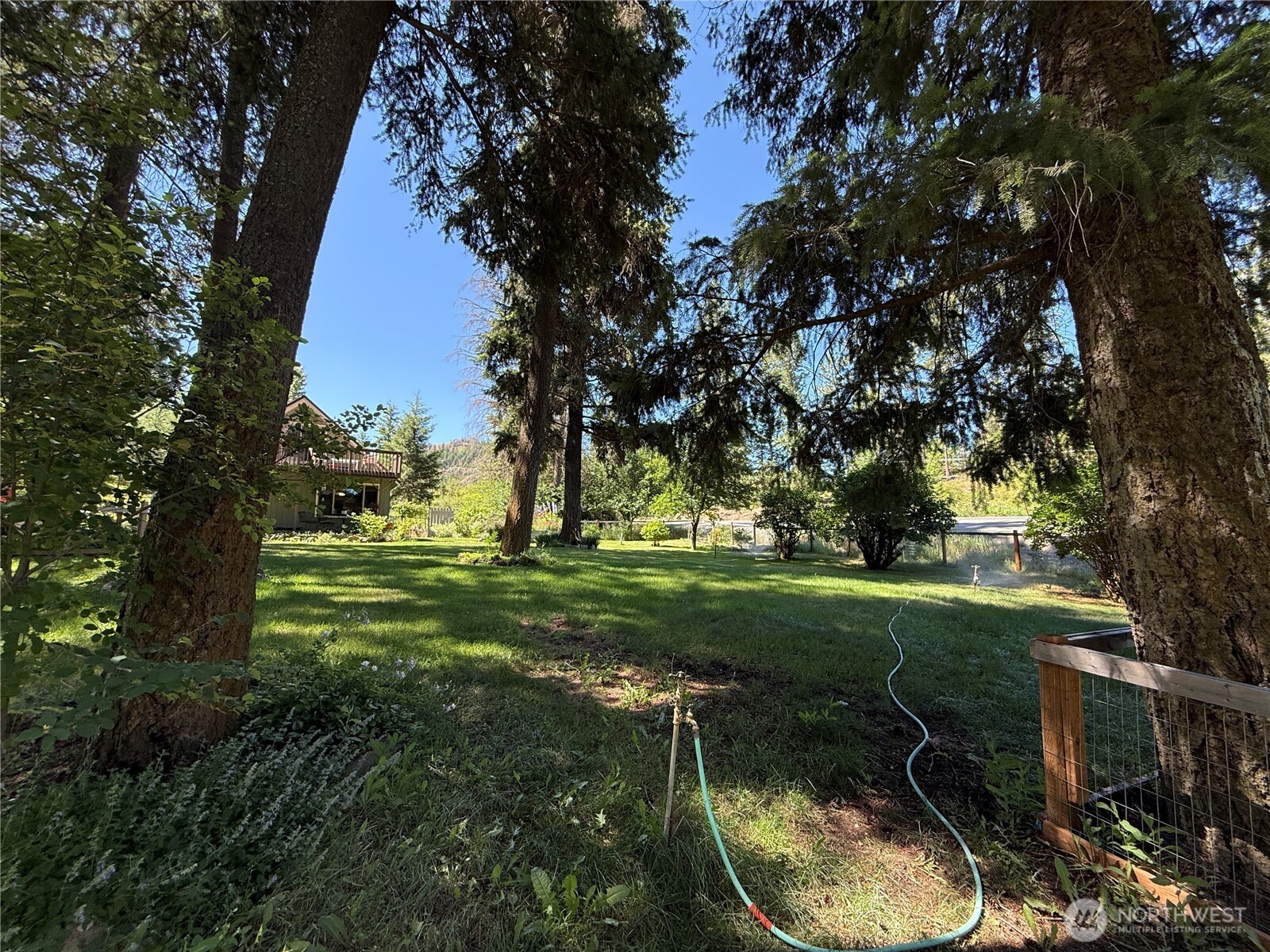 30545 State Rte 20 Republic, WA 99166 - Photo 32 of 35 a backyard of a house with a yard fire pit and large trees