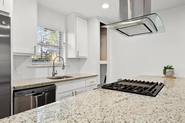 a kitchen with a stove and a sink