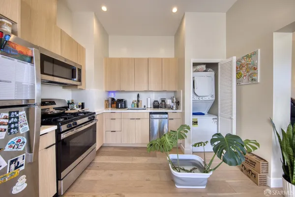 a kitchen with stainless steel appliances kitchen island granite countertop a stove a sink and a microwave
