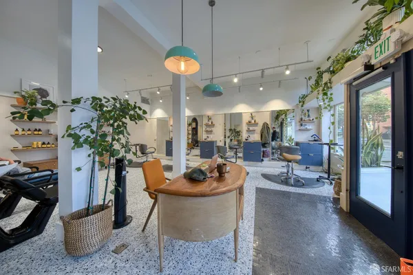 a dining room with furniture and a potted plant