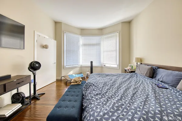 a bedroom with a bed and a chandelier