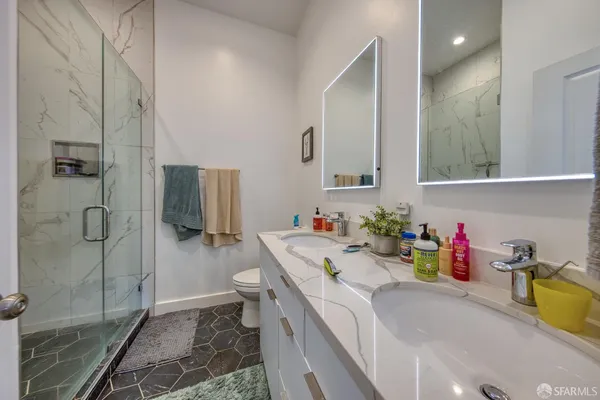 a bathroom with a sink mirror vanity and toilet