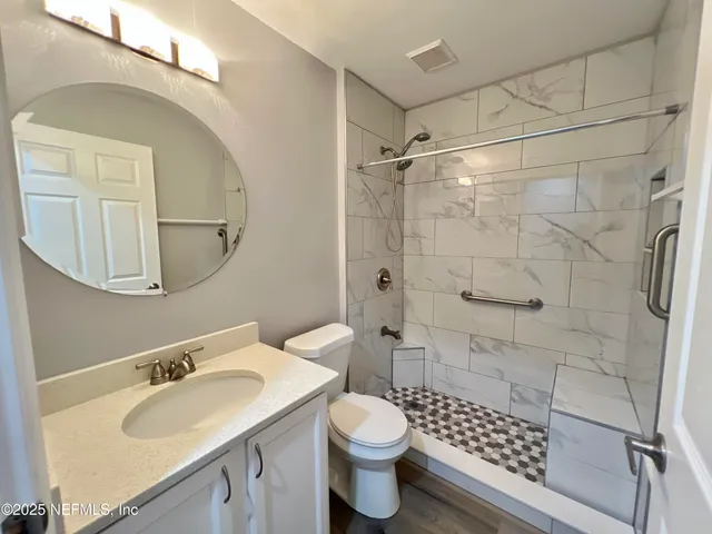 wooden floor in an empty room with a mirror