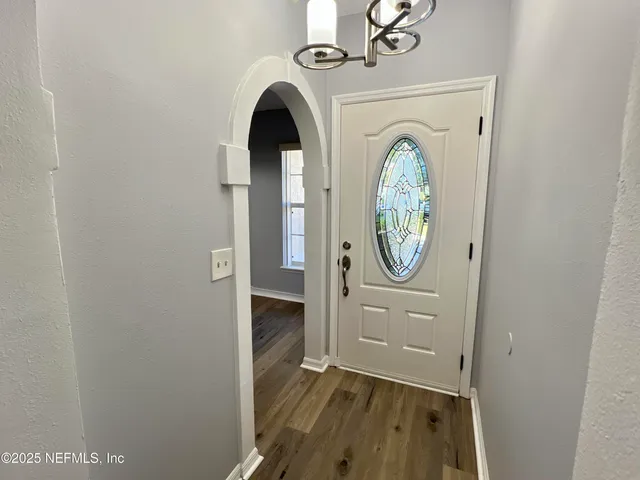 a kitchen with granite countertop a sink a stove and cabinets