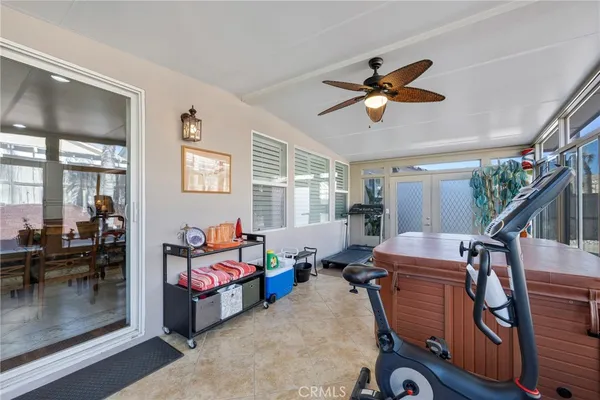 a kitchen with stainless steel appliances granite countertop a stove top oven a sink dishwasher a dining table and chairs with wooden floor