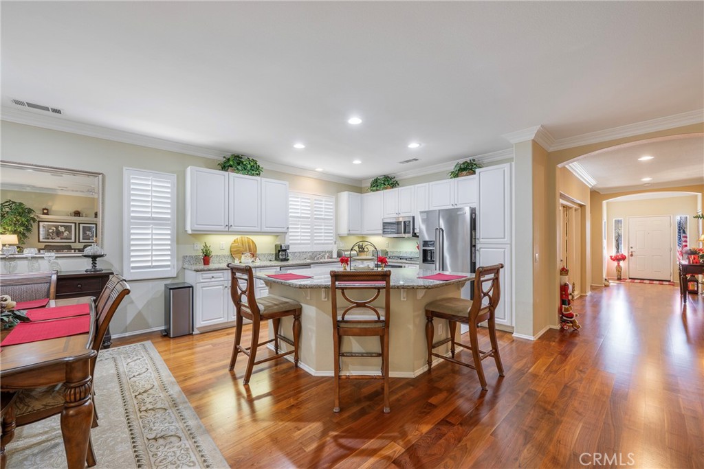 27956 Crystal Spring Drive Menifee, CA 92584 - Photo 29 of 75 a view of a dining room with furniture and wooden floor