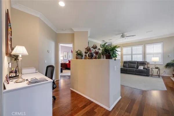 a living room with furniture and a book shelf