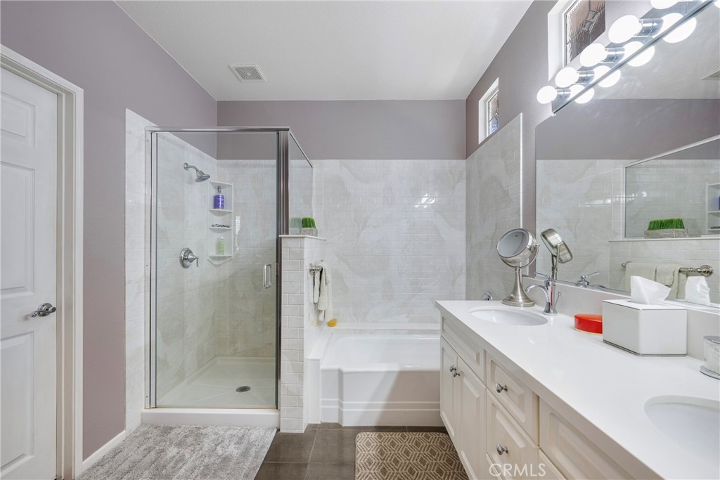 27956 Crystal Spring Drive Menifee, CA 92584 - Photo 41 of 75 a bathroom with a tub sink shower and two mirror