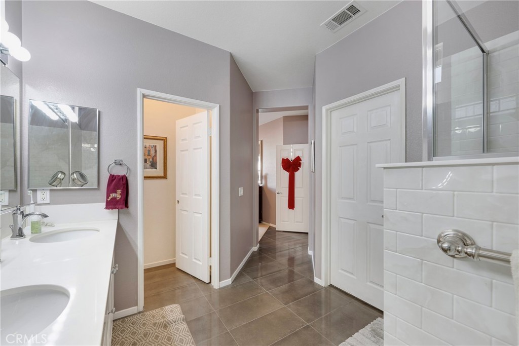 27956 Crystal Spring Drive Menifee, CA 92584 - Photo 42 of 75 a bathroom with a sink and a mirror