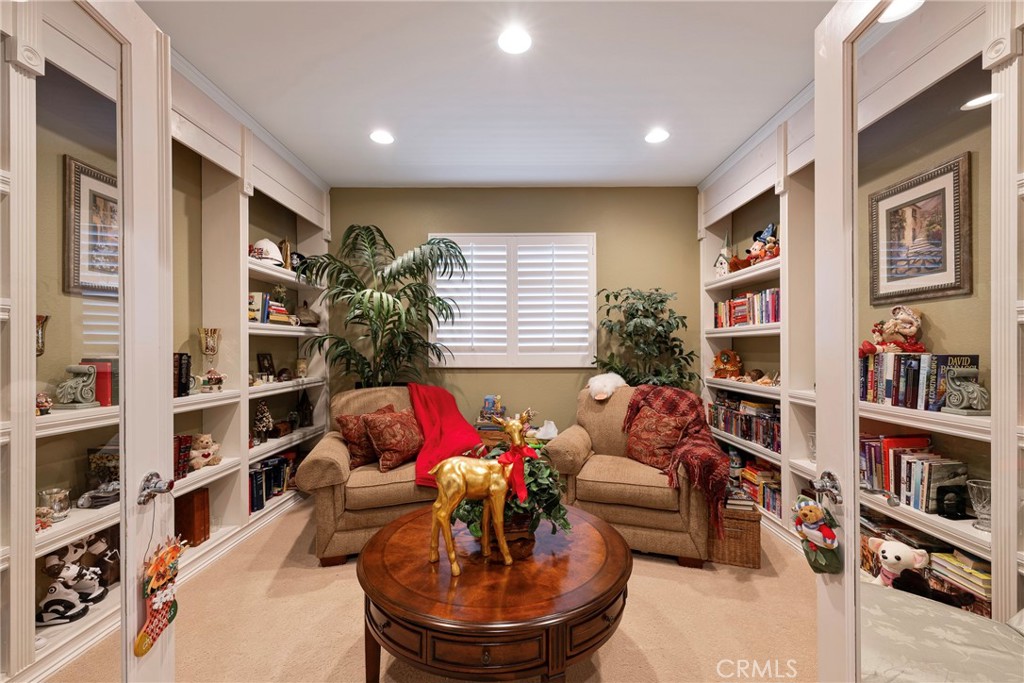 27956 Crystal Spring Drive Menifee, CA 92584 - Photo 47 of 75 a living room with furniture and a book shelf