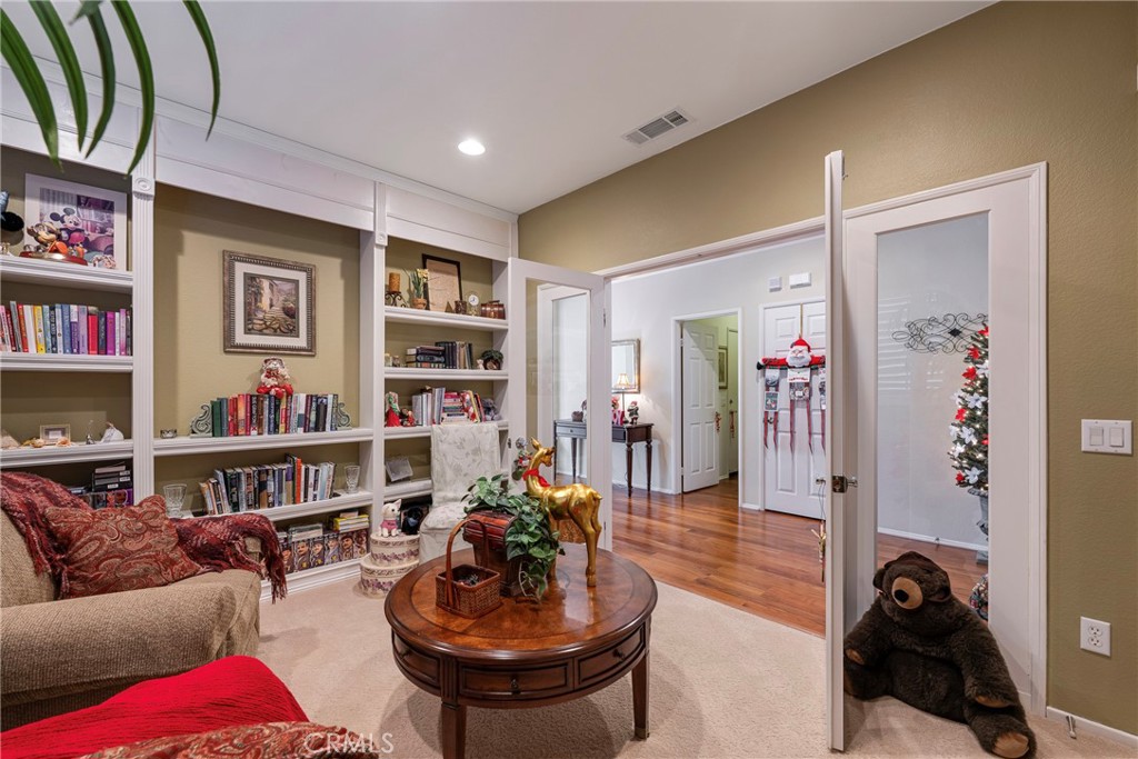27956 Crystal Spring Drive Menifee, CA 92584 - Photo 48 of 75 a living room with furniture and a book shelf