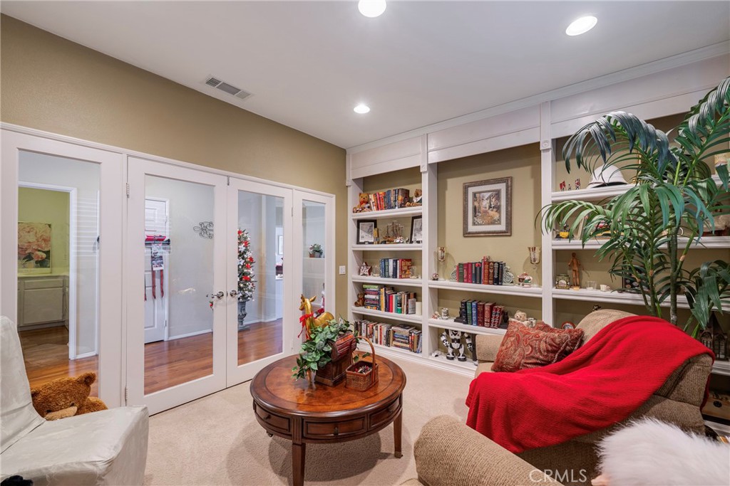 27956 Crystal Spring Drive Menifee, CA 92584 - Photo 49 of 75 a living room with furniture and a book shelf