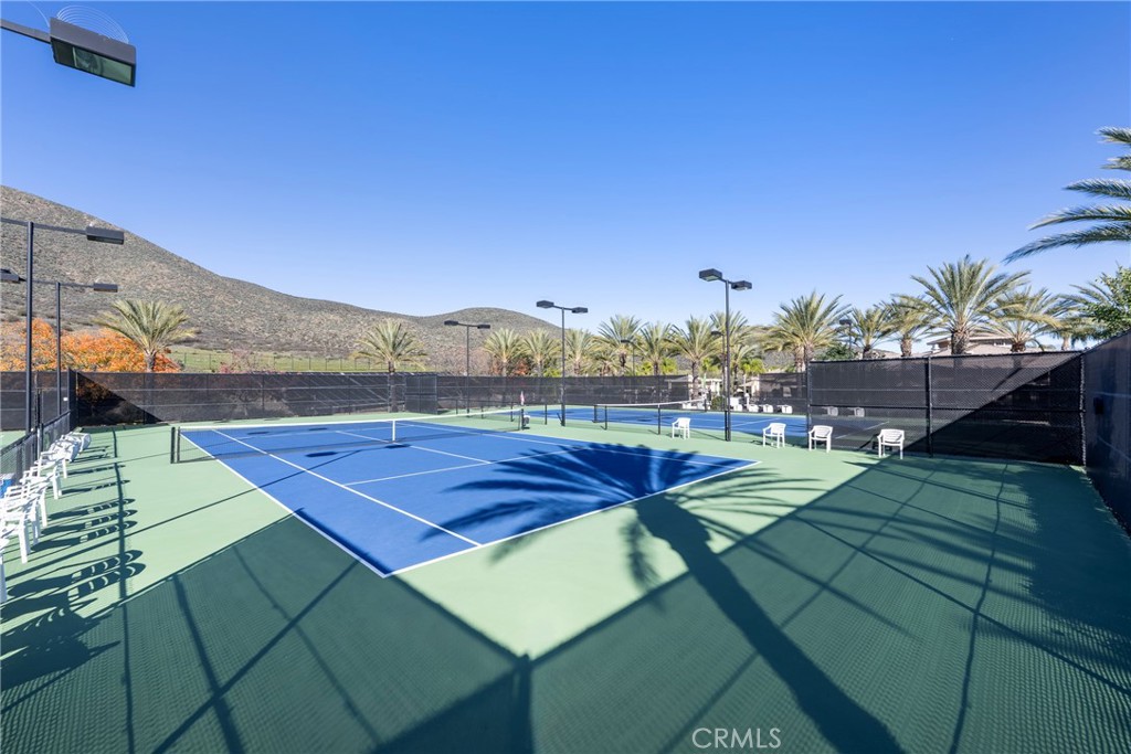 27956 Crystal Spring Drive Menifee, CA 92584 - Photo 66 of 75 a view of a tennis ground with seating area